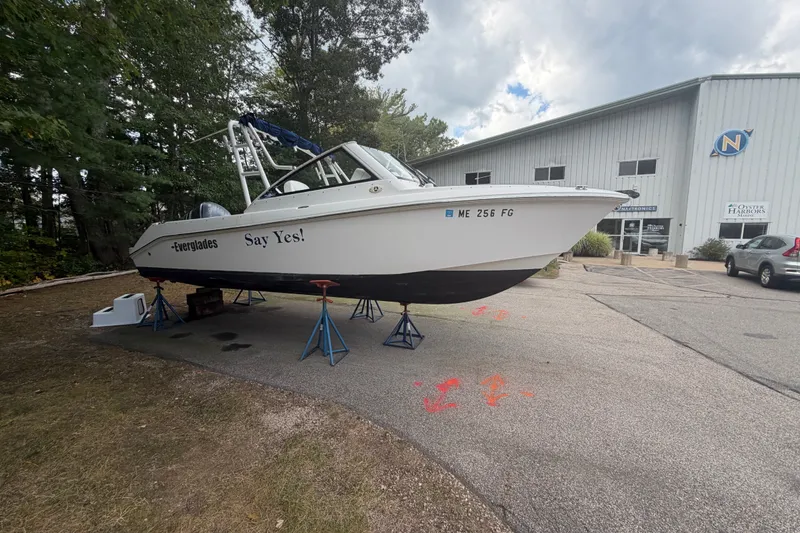 Slide: The Image of 2012 Everglades 230 Dual Console boat on stands outside a marine service building. - 7