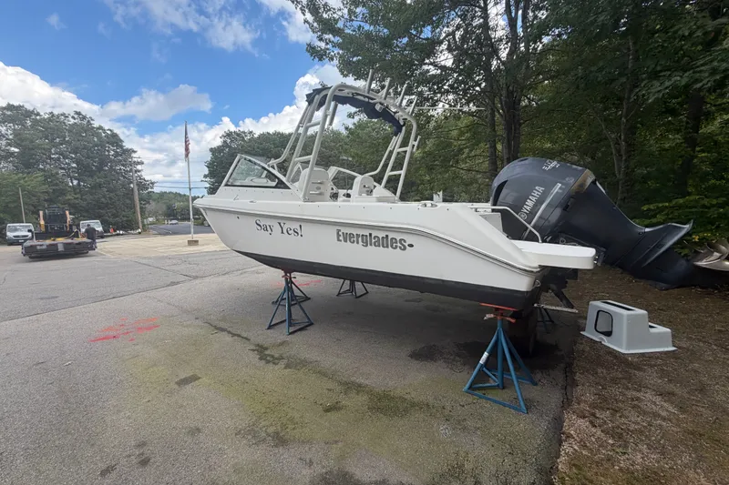 Slide: The Image of 2012 Everglades 230 Dual Console boat on stands, outdoors, with Yamaha engine. - 3