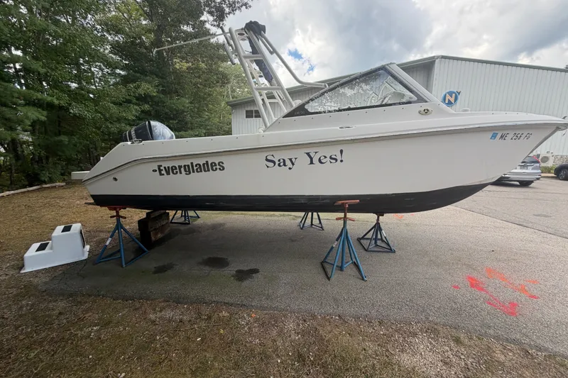 Slide: The Image of 2012 Everglades 230 Dual Console boat on stands, outdoors, with "Say Yes!" text. - 6