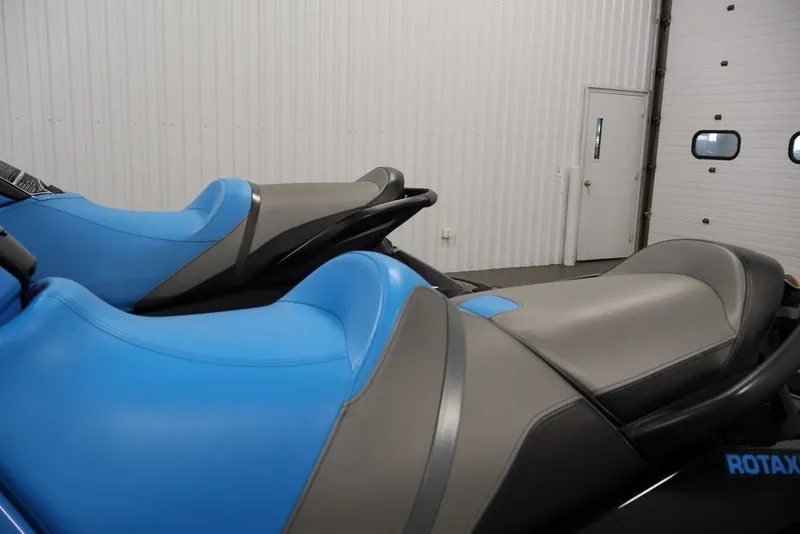 Slide: The Image of 2018 Sea-Doo RXT 230 jet ski with blue and gray seats in a garage. - 32