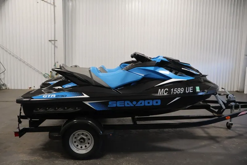 Slide: The Image of 2018 Sea-Doo RXT 230 jet ski on trailer in indoor setting. - 29