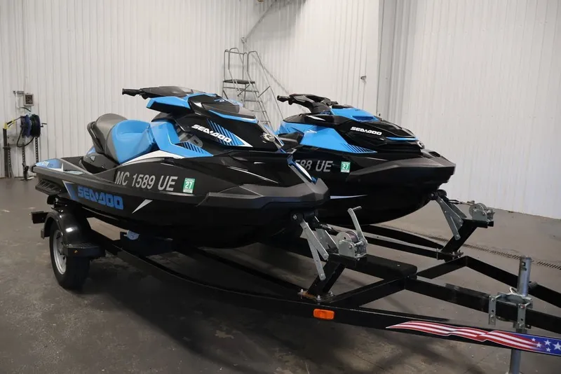 Slide: The Image of 2018 Sea-Doo RXT 230 jet skis on trailer in indoor storage. - 30