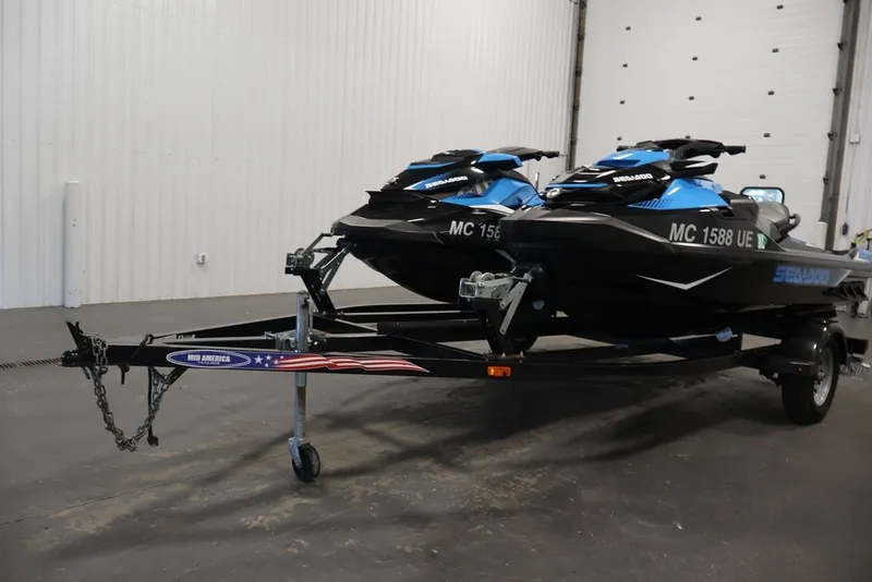 Slide: The Image of 2018 Sea-Doo RXT 230 jet skis on trailer in indoor storage facility. - 35