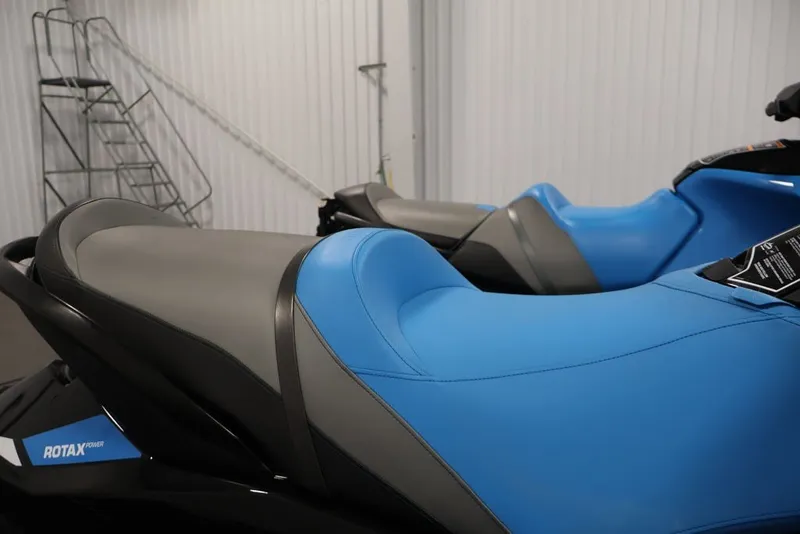Slide: The Image of 2018 Sea-Doo RXT 230 jet ski with blue and gray seating in a storage area. - 31
