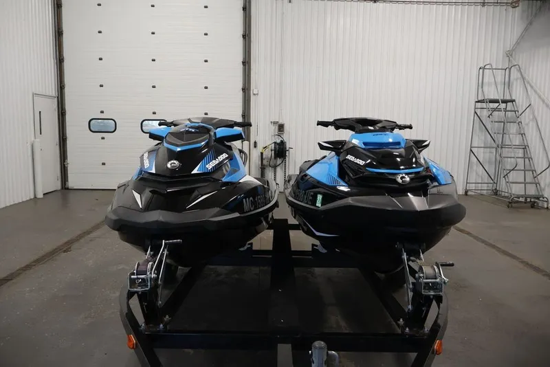 Slide: The Image of 2018 Sea-Doo RXT 230 jet skis on trailer in garage setting. - 24