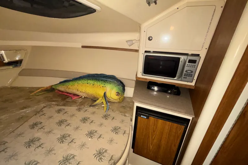 Slide: The Image of Interior of 2007 Scout 262 Abaco boat with microwave, fridge, and fish decor. - 18