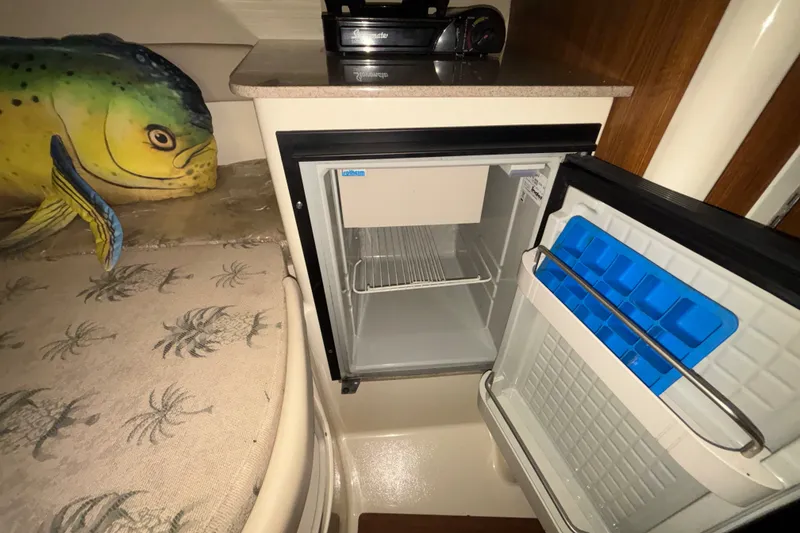 Slide: The Image of 2007 Scout 262 Abaco cabin with open fridge and fish-themed decor. - 19