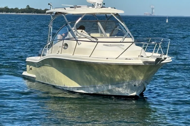 The Image of 2007 Scout 262 Abaco boat cruising on open water under clear skies. - 0