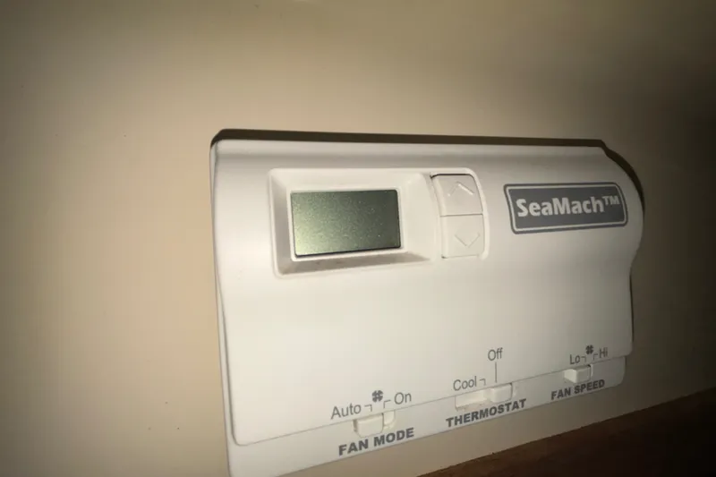 Slide: The Image of Thermostat control panel labeled "SeaMach" with fan mode and speed settings. - 22