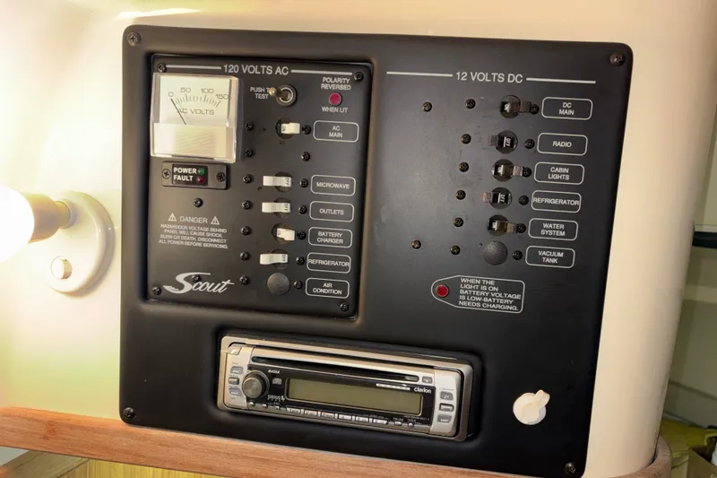 Slide: The Image of Electrical control panel of a 2007 Scout 262 Abaco boat, featuring AC and DC switches. - 21