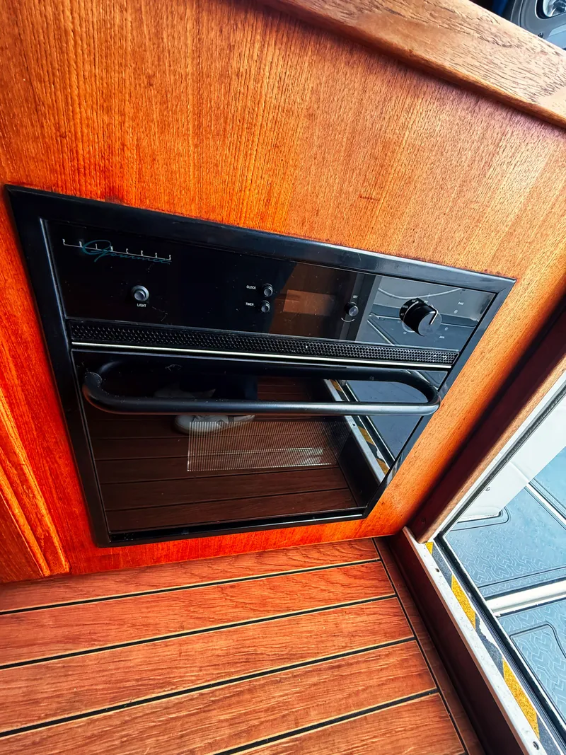 Slide: The Image of A built-in oven in a wooden cabinet with a wood floor. - 8
