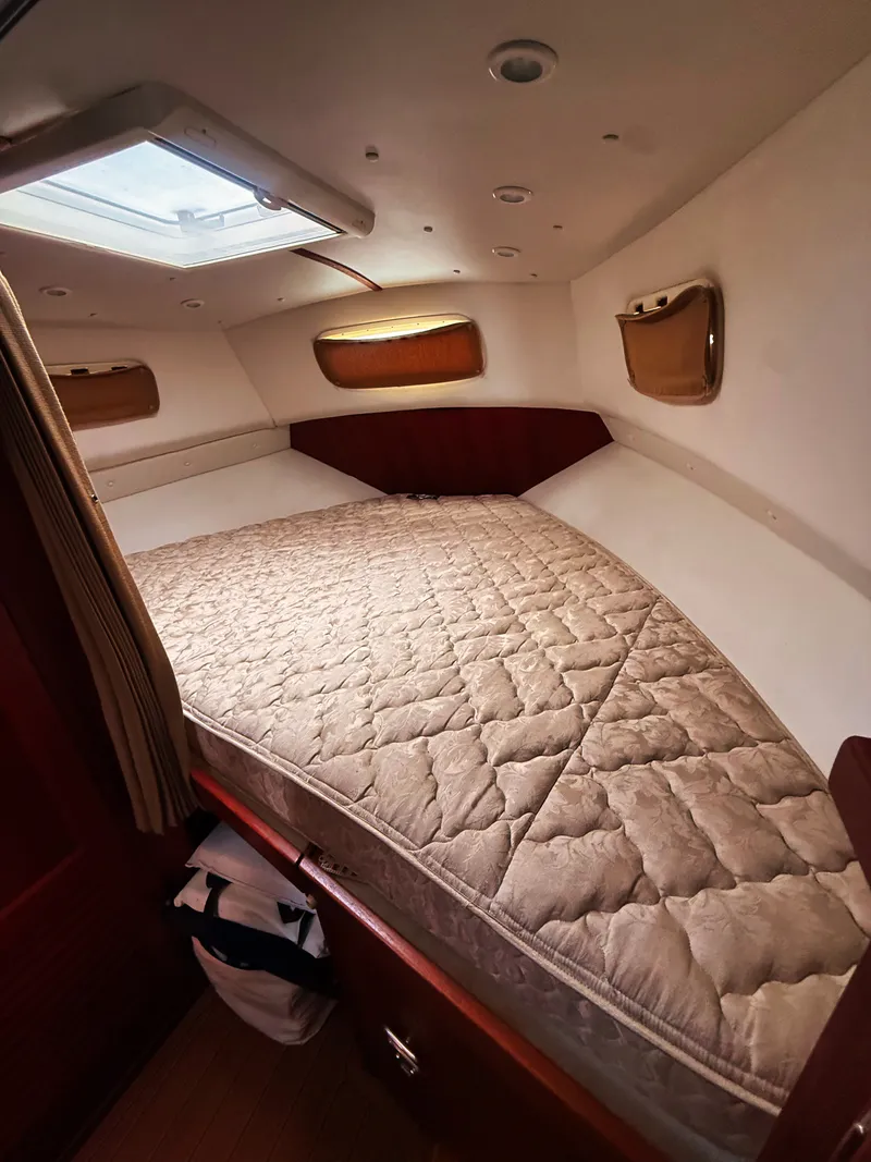 Slide: The Image of Cabin with a large cushioned bed and several windows. - 11