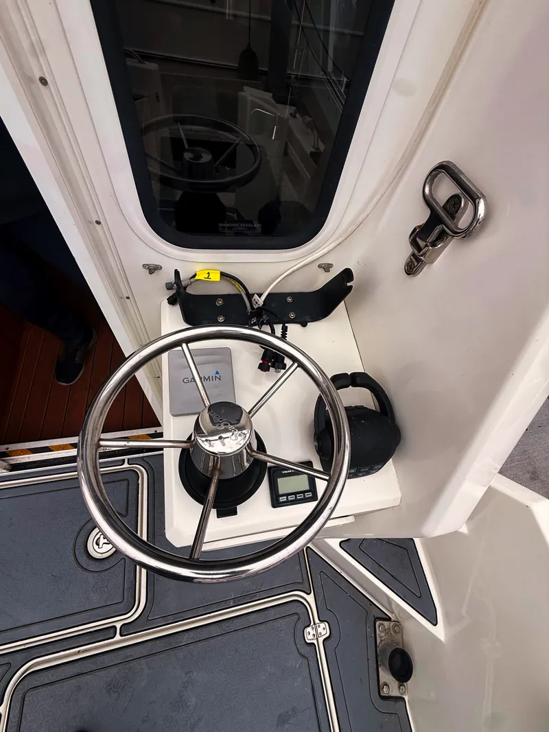 Slide: The Image of Helm of the SeaSport Voyager 3000 with steering wheel and navigation system. - 23