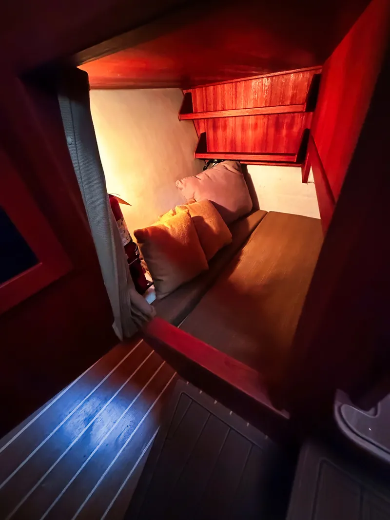 Slide: The Image of Cabin with cozy bed and pillows, wooden walls and shelves. - 13