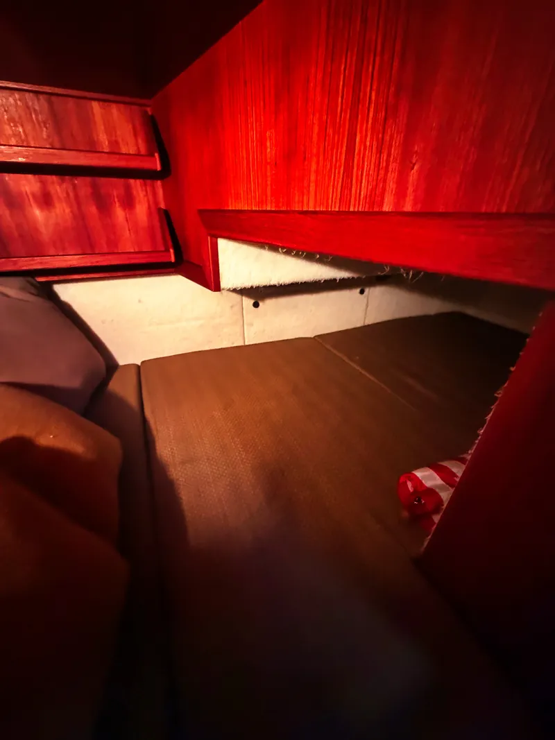 Slide: The Image of Interior of the 2005 SeaSport Voyager 3000 with wooden walls and a sleeping area. - 14