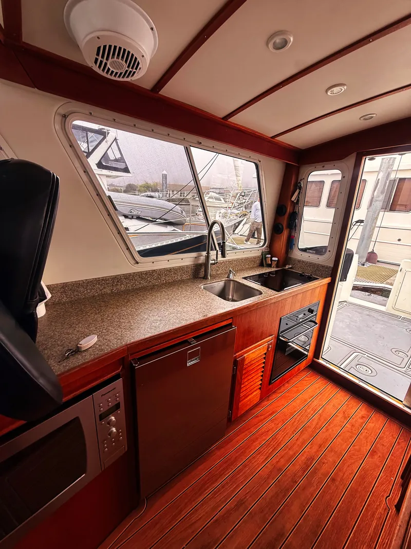 Slide: The Image of Interior of the 2005 SeaSport Voyager 3000 with kitchen and wooden floor. - 6