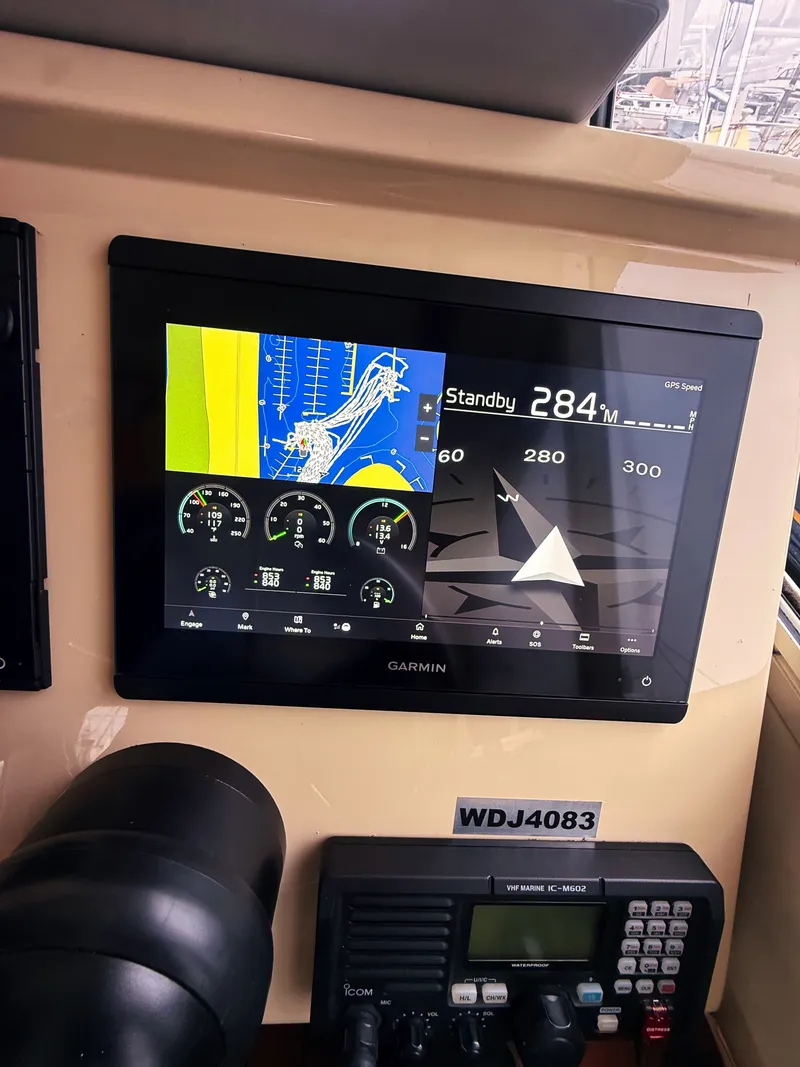Slide: The Image of The image shows a Garmin navigation system on a boat, surrounded by various control instruments. - 5