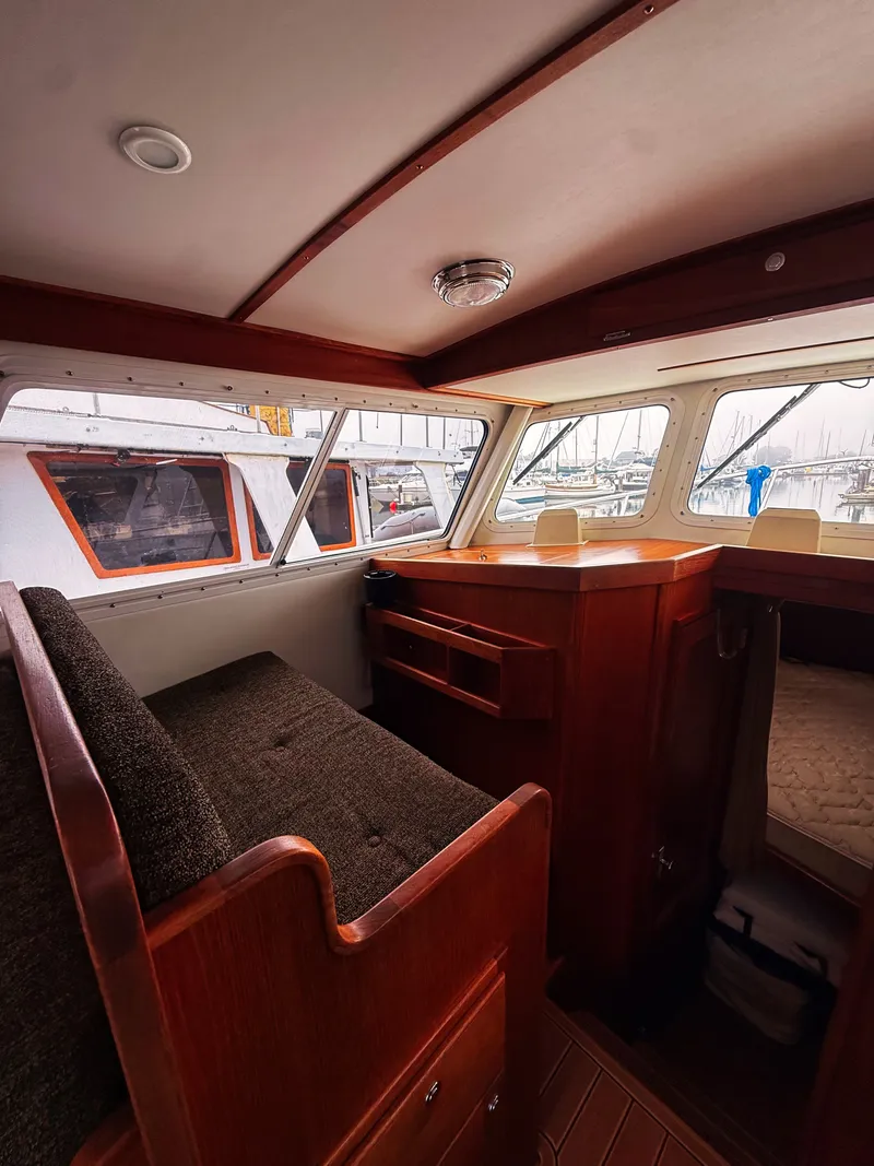 Slide: The Image of Interior of the 2005 SeaSport Voyager 3000 with wooden furnishings and cushioned seating. - 3