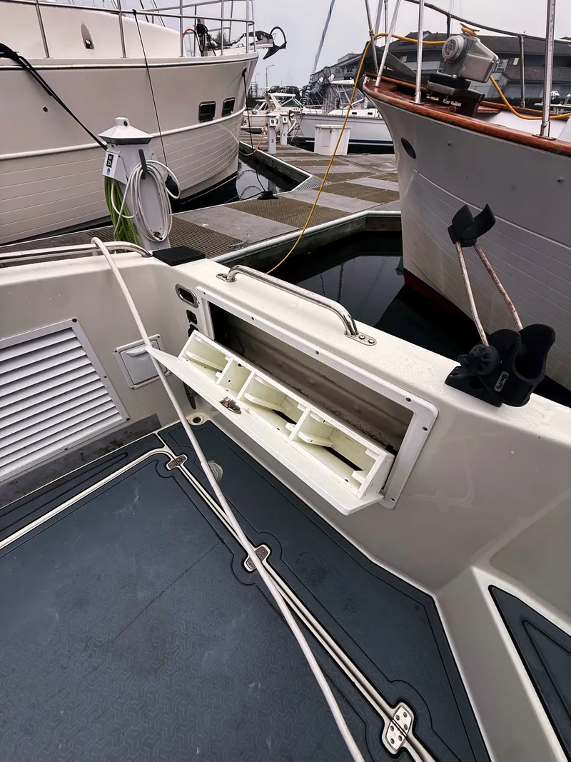 Slide: The Image of The image shows the deck of a 2005 SeaSport Voyager 3000 with storage compartments and ropes. - 24
