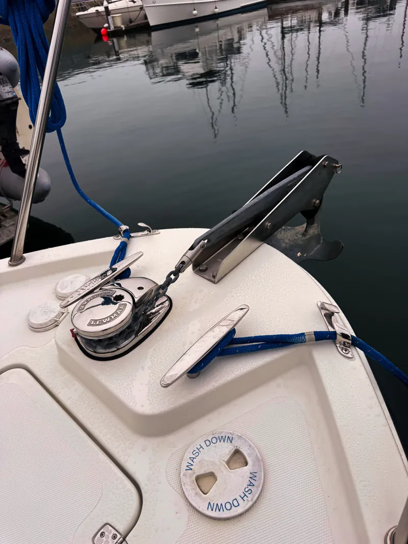 Slide: The Image of The image shows the bow of a boat with an anchor windlass and blue ropes. - 21