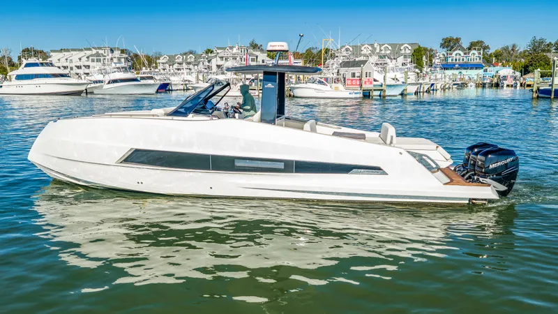 Slide: The Image of A modern 2023 Astondoa 377 Coupe Outboard on calm water, surrounded by other boats. - 23