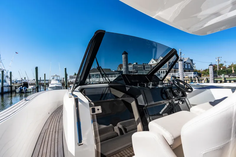 Slide: The Image of The image shows the cockpit of a 2023 Astondoa 377 Coupe Outboard with a modern design. - 49
