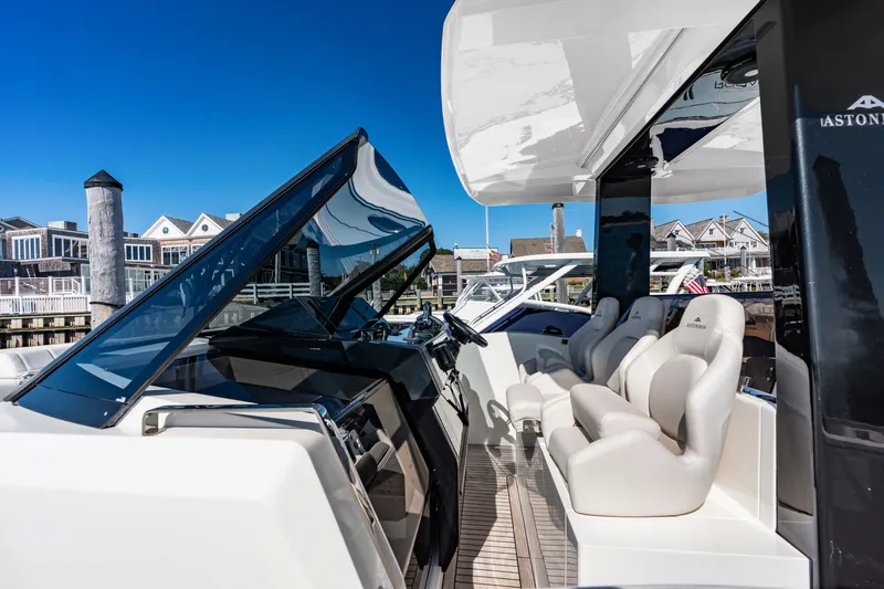 Slide: The Image of The image shows the cockpit of a 2023 Astondoa 377 Coupe Outboard with luxurious seating. - 33