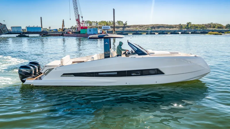 Slide: The Image of The 2023 Astondoa 377 Coupe Outboard glides on calm water. It features a sleek design and twin outboard engines. - 14