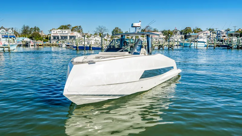 Slide: The Image of The 2023 Astondoa 377 Coupe Outboard is a sleek, modern boat docked in a harbor. - 21
