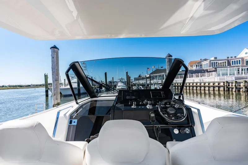 Slide: The Image of The 2023 Astondoa 377 Coupe Outboard cockpit features modern controls and comfortable seating. - 46