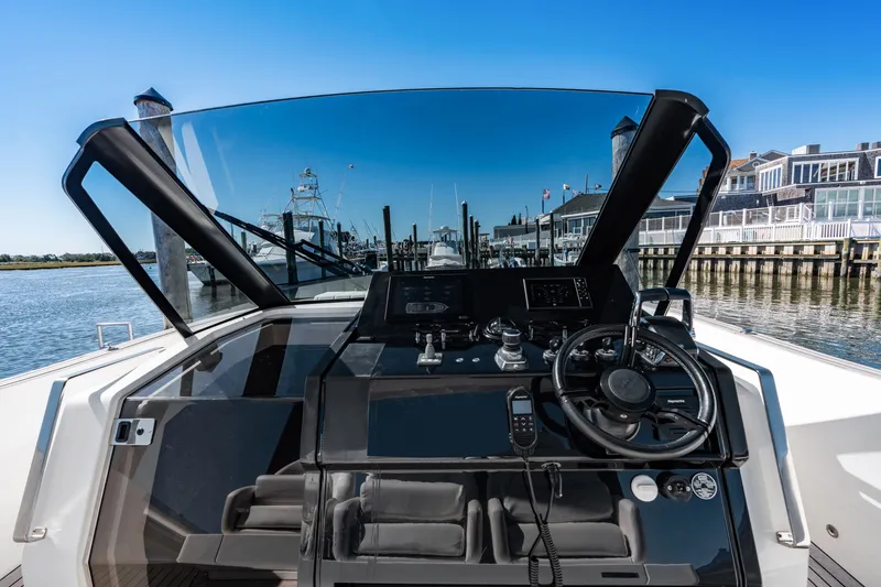 Slide: The Image of The image shows the cockpit of a 2023 Astondoa 377 Coupe Outboard with a modern helm. - 48