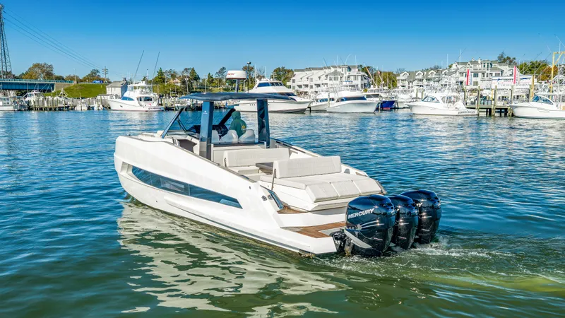 Slide: The Image of Astondoa 377 Coupe Outboard 2023 on the water with three Mercury outboard engines. - 24