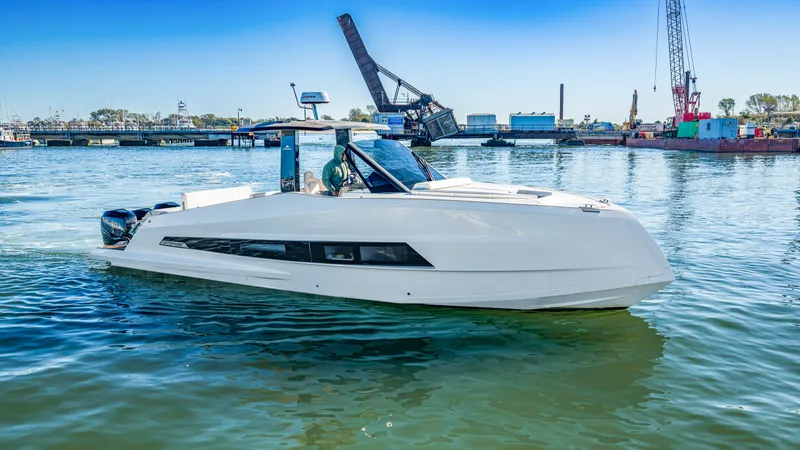 Slide: The Image of A modern 2023 Astondoa 377 Coupe Outboard cruising on calm waters in a harbor. - 16