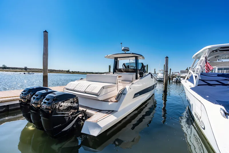 Slide: The Image of Astondoa 377 Coupe Outboard 2023 at dock with three Mercury outboard engines. - 28