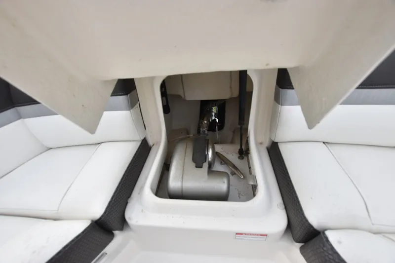 Slide: The Image of 2018 Sea Ray SLX 350 boat storage compartment with white seating and mechanical components. - 8