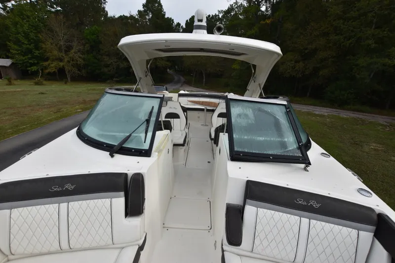 Slide: The Image of 2018 Sea Ray SLX 350 boat with open cockpit and windshield, surrounded by greenery. - 9