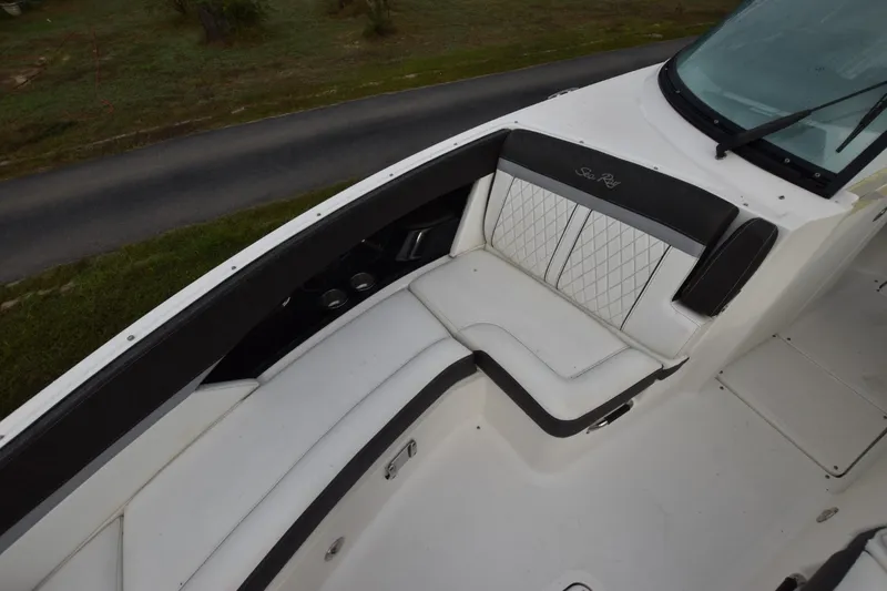 Slide: The Image of 2018 Sea Ray SLX 350 boat interior with white cushioned seating and black accents. - 10