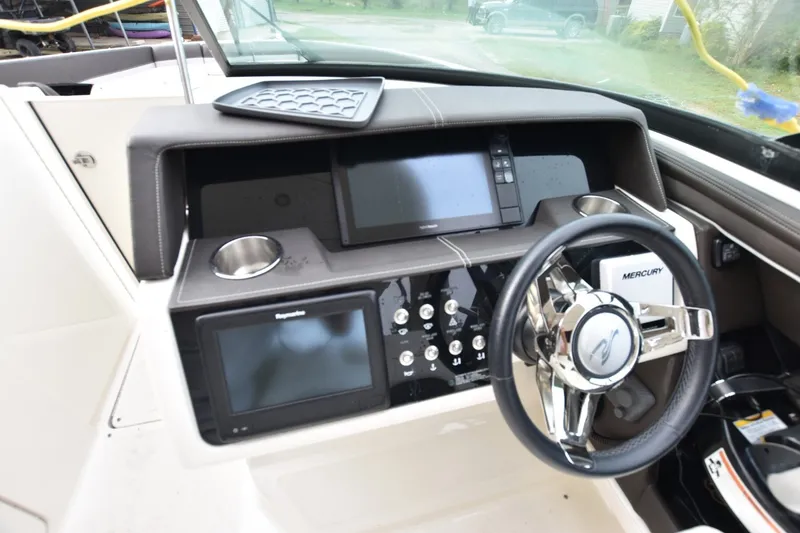 Slide: The Image of 2018 Sea Ray SLX 350 dashboard with modern controls and Mercury steering wheel. - 18