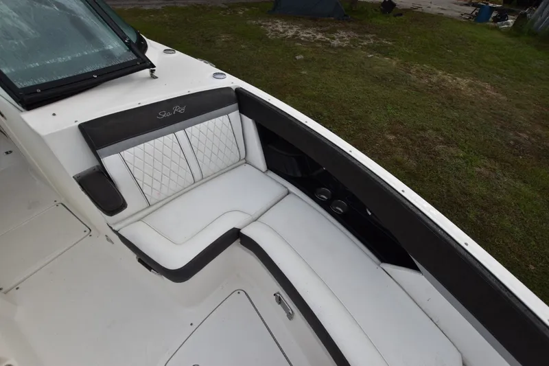Slide: The Image of 2018 Sea Ray SLX 350 boat interior with white cushioned seating and black accents. - 11