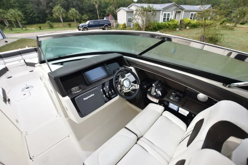 Slide: The Image of 2018 Sea Ray SLX 350 boat cockpit with steering wheel and navigation system. - 13