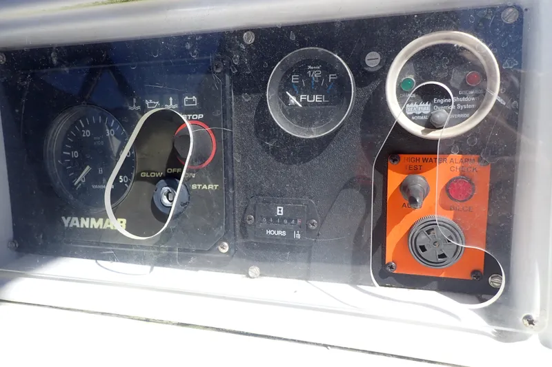 Slide: The Image of Control panel of a 2008 Hunter 33 sailboat featuring Yanmar engine gauges. - 48