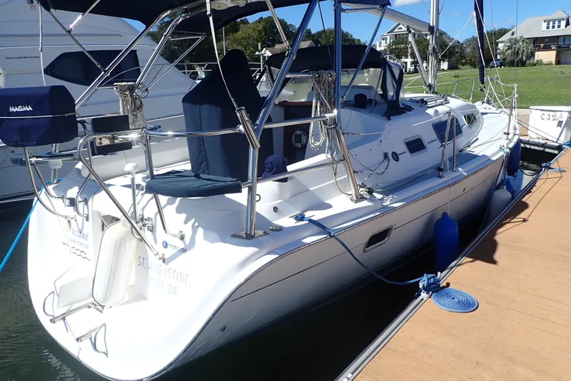 Slide: The Image of 2008 Hunter 33 sailboat docked, featuring sleek design and modern amenities. - 2