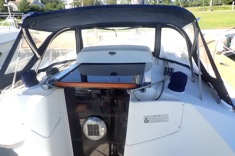 Slide: The Image of Cockpit of a 2008 Hunter 33 sailboat with protective canopy and control panel. - 7