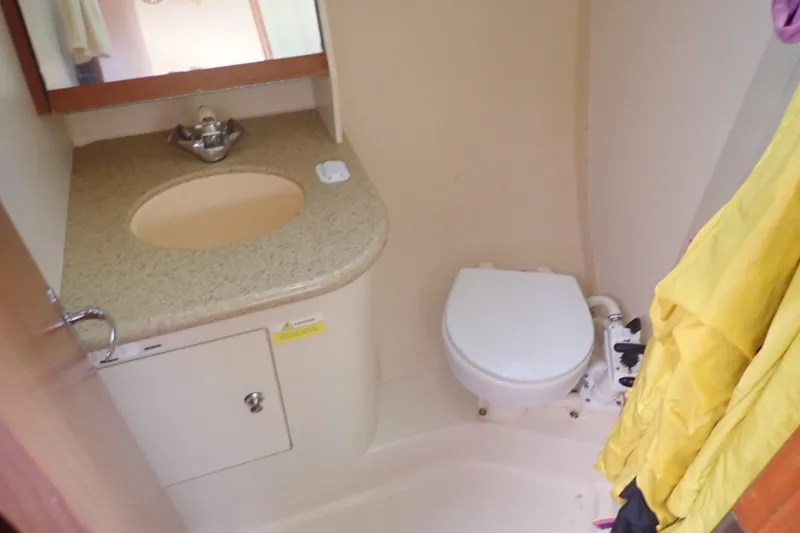 Slide: The Image of Compact bathroom in 2008 Hunter 33 yacht with sink, toilet, and mirror. - 33