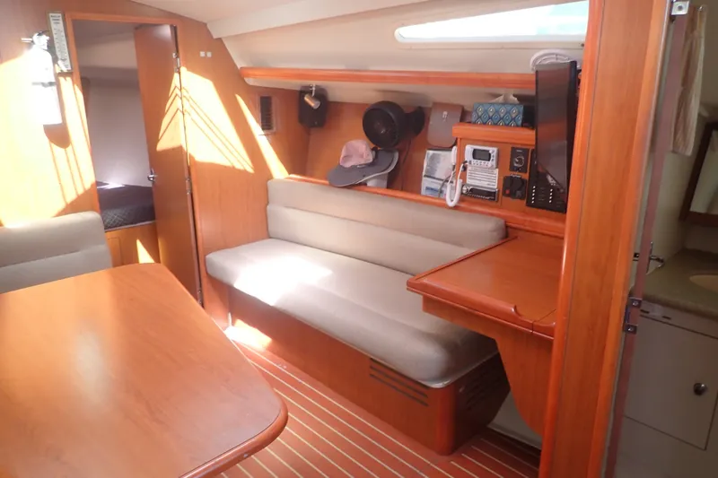 Slide: The Image of Interior of a 2008 Hunter 33 sailboat with wooden furnishings and seating area. - 18