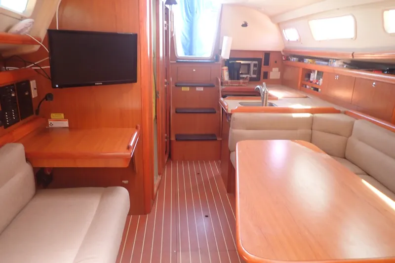 Slide: The Image of Interior of a 2008 Hunter 33 sailboat with wood finish and cozy seating area. - 13