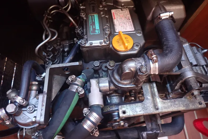 Slide: The Image of Engine of a 2008 Hunter 33 sailboat, showcasing hoses and mechanical components. - 45