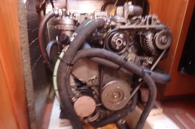 Slide: The Image of Engine of a 2008 Hunter 33 sailboat, featuring hoses and mechanical components. - 42