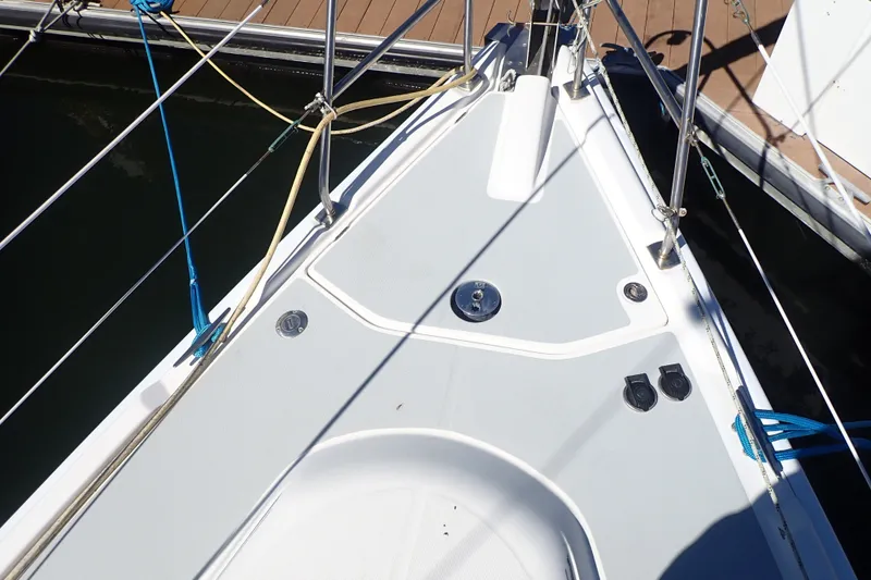 Slide: The Image of Bow of a 2008 Hunter 33 sailboat docked, featuring deck fittings and rigging. - 38