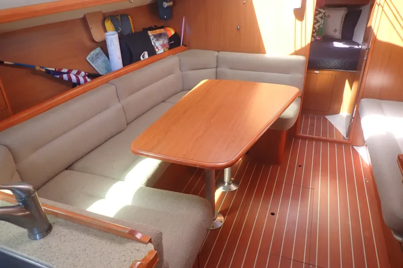 Slide: The Image of Interior of 2008 Hunter 33 sailboat with cozy seating and wooden table. - 19
